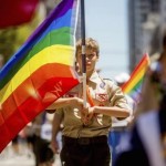 Boy Scout Casey Chambers carries a rainbow flag during the San Francisco Gay Pride Festival in California June 29, 2014. REUTERS/Noah Berger