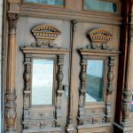 Ornate carved wooden doors to a building.