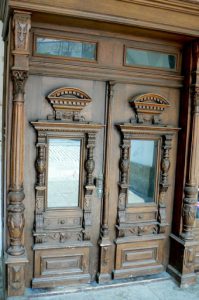 Ornate carved wooden doors to a building.