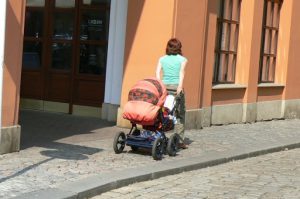 Colorful image of a mom pulling her well-equipped baby carriage