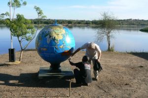 Murchison Falls National Park visitors inspecting globe by the River