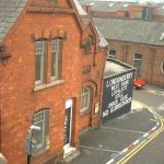 Derry protestant neighborhood with defiant curb colors and wall slogan