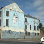 Belfast - Burned out former hostel with 'Virgin' wall mural