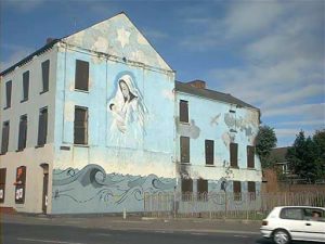 Belfast - Burned out former hostel with 'Virgin' wall mural