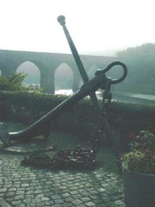 Old railroad bridge and ship's anchor