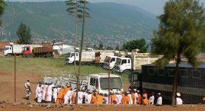Prisoners (in pink and orange) pushing a truck in Kigali.