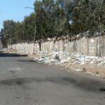 Trash along a charred road. Collectors were afraid to enter