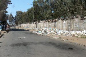 Trash along a charred road. Collectors were afraid to enter