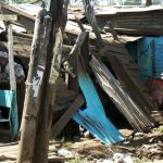 Two women huddled in their damaged homes.