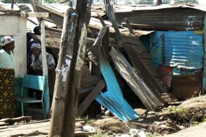 Two women huddled in their damaged homes.