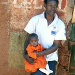 A young father holds his baby. Family planning is difficult