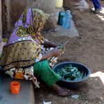 A woman prepares what meager food she has for lunch