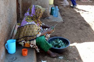 A woman prepares what meager food she has for lunch