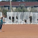 A playground with damaged fences. Rioters become hysterical in their violence