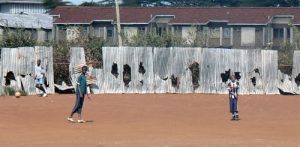 A playground with damaged fences. Rioters become hysterical in their violence