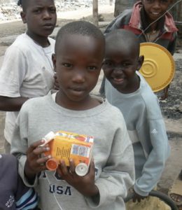 A cherubic-faced boy and his valued toy truck made form