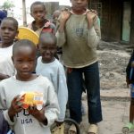 The same cherubic-faced boy with his toy and friends.