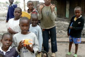 The same cherubic-faced boy with his toy and friends.