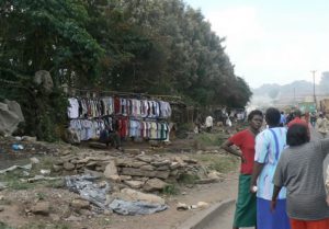 Clothing for sale hung on poles stuck in the ground