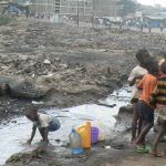 Kids playing in the rubble-strewn and charred area of a