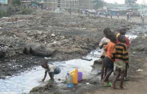 Kids playing in the rubble-strewn and charred area of a