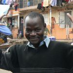 A smiling resident of Methare displays his resilience and hope