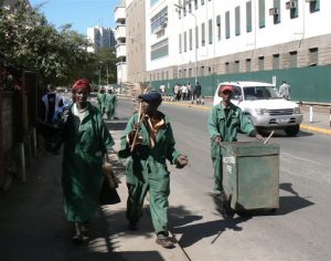 Nairobi downtown - street sweepers carry on their work even