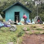 Porters' primitive sleeping lodge at first base camp on the