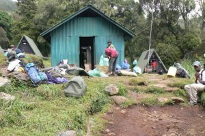 Porters' primitive sleeping lodge at first base camp on the