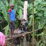 Sawing planks by hand along the village road in Marangu. As