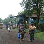 Busy village road in Marangu with colorfully clothed women.