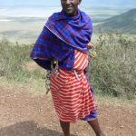 Maasai man selling souvenirs to tourists.