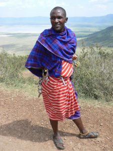 Maasai man selling souvenirs to tourists.
