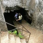 Exploring a cave in the extensive volcanic rocks on the