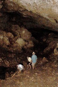 Exploring a cave in the extensive volcanic rocks on the