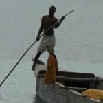 Fisherman navigates his boat.