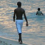 Swimmers in the ocean during sunset