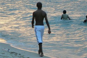 Swimmers in the ocean during sunset