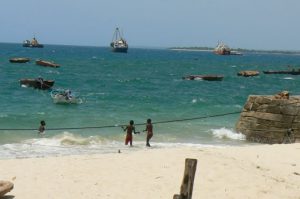 Orphan kids playing by the sea.