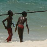 Orphan kids playing by the sea.