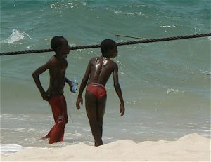 Orphan kids playing by the sea.