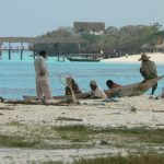 Locals waiting for business from the 5-star resort beyond.