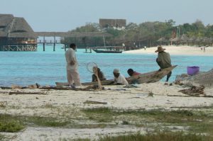 Locals waiting for business from the 5-star resort beyond.