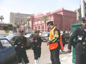 Cairo police always on alert; Cairo Museum in background.