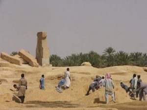 Moving sand piles by hand.