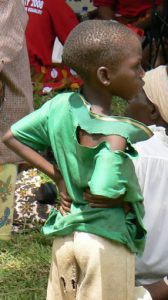 Impoverished boy watching women's rally.