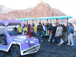 Bizarre Disney-esque mini-trains shuttle tourists from the parking lot to