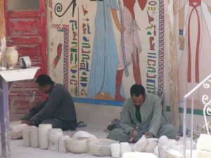 Carving alabaster objects at local souvenir shops in the Valley