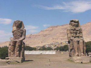 The Colossi of Memnon are two massive stone statues of