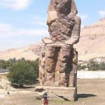 The Colossi of Memnon are two massive stone statues of